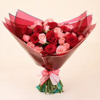Ruby Rose Embrace red and pink rose bouquet in Bangalore with deep red roses, blush pink roses, red wrapping, and ribbon by Rapid Petals by Yashken Fresh