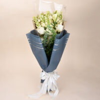 Ivory Tuberose Grace white rose and tuberose bouquet with eucalyptus, blue-grey wrap, and white ribbon by Rapid Petals by Yashken Fresh