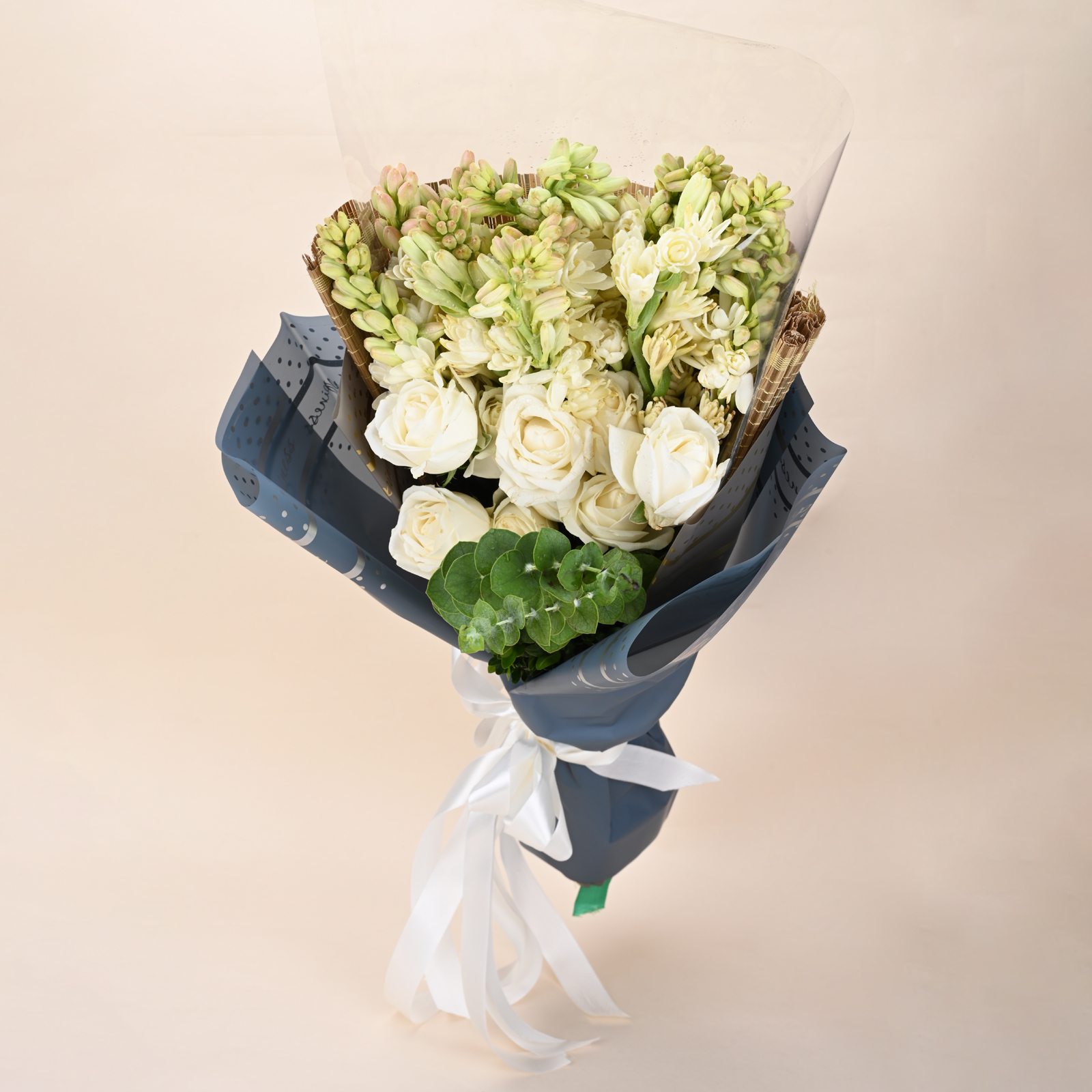 Ivory Tuberose Grace white rose and tuberose bouquet in blue wrap by Rapid Petals by Yashken Fresh
