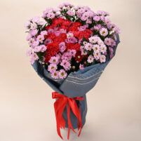 Ruby Blush Garden mixed flower bouquet with red textured blooms, pink chrysanthemums, lavender roses, blue-grey wrap, and red ribbon by Rapid Petals by Yashken Fresh