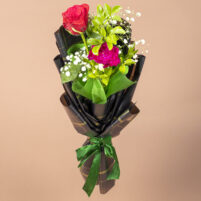 Crimson Emerald Duet red rose and pink carnation bouquet with white fillers, green foliage, black-gold wrapping and green ribbon