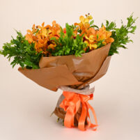 Orange Orchid Glow orange orchid bouquet with red roses, deep red blooms, fresh greenery, brown wrap, and orange ribbon by Rapid Petals by Yashken Fresh