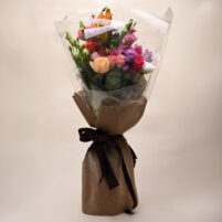 Pastel Rose Bouquet with peach roses, pink roses, orange lily-style blooms, purple flowers, white blooms, clear wrap, jute-style wrap, and dark purple ribbon by Rapid Petals by Yashken Fresh