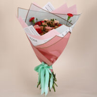 Peach Rose Delight peach rose bouquet with red carnations, soft brown fillers, pastel pink wrap, newspaper-style floral sheet, and mint ribbon by Rapid Petals by Yashken Fresh