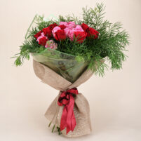 Red Pink Rose Garden red and pink rose bouquet with fresh green leafy fillers, green transparent wrap, natural jute-style wrapping, and red ribbon by Rapid Petals by Yashken Fresh
