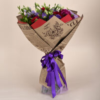 Ruby Violet Royale red rose and violet lisianthus bouquet with magenta carnations, newspaper-style wrap, and purple ribbon by Rapid Petals by Yashken Fresh