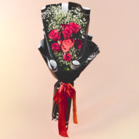 Crimson Velvet Rose Charm red rose bouquet with peach rose, baby’s breath, fresh greenery, black patterned wrap, and red ribbon by Rapid Petals by Yashken Fresh