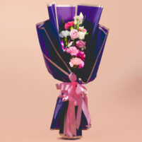 Lavender Pink Charm pink purple flower bouquet with carnations, white blooms, fresh greenery, deep purple wrap, silver border paper, and pink ribbon by Rapid Petals by Yashken Fresh