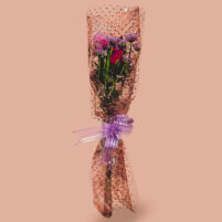 Mauve Net Charm red and pink flower bouquet with red rose, pink rose, mauve blooms, brown net wrap, clear dotted paper, and purple ribbon by Rapid Petals by Yashken Fresh