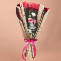 Ruby Pink Bloom red pink flower bouquet with red blooms, pink rose, white carnation, eucalyptus leaves, newspaper-style wrap, and pink ribbon by Rapid Petals by Yashken Fresh