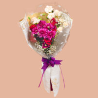 Ruby Plum Garden red and pink flower bouquet with red roses, pink chrysanthemums, peach carnations, baby’s breath, clear wrap, newspaper-style paper, and purple ribbon by Rapid Petals by Yashken Fresh