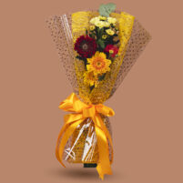 Sunlit Garden Glow yellow flower bouquet with yellow gerbera-style blooms, red flower, eucalyptus, clear dotted wrap, yellow net, and ribbon by Rapid Petals by Yashken Fresh